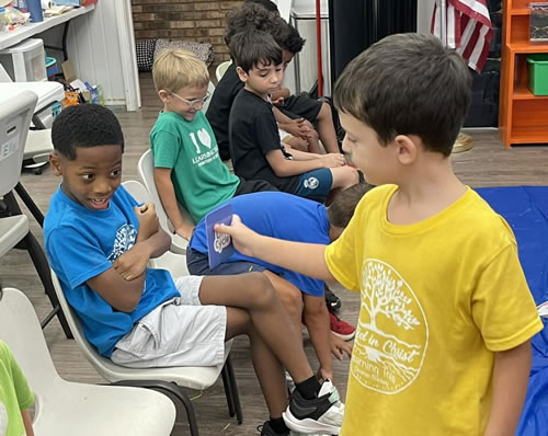 Kids identifying the type of bug using show cards.