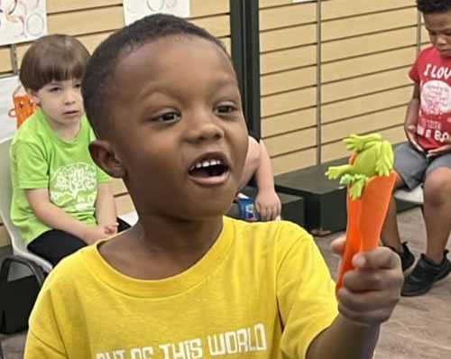 Student enjoying looking at a frog.