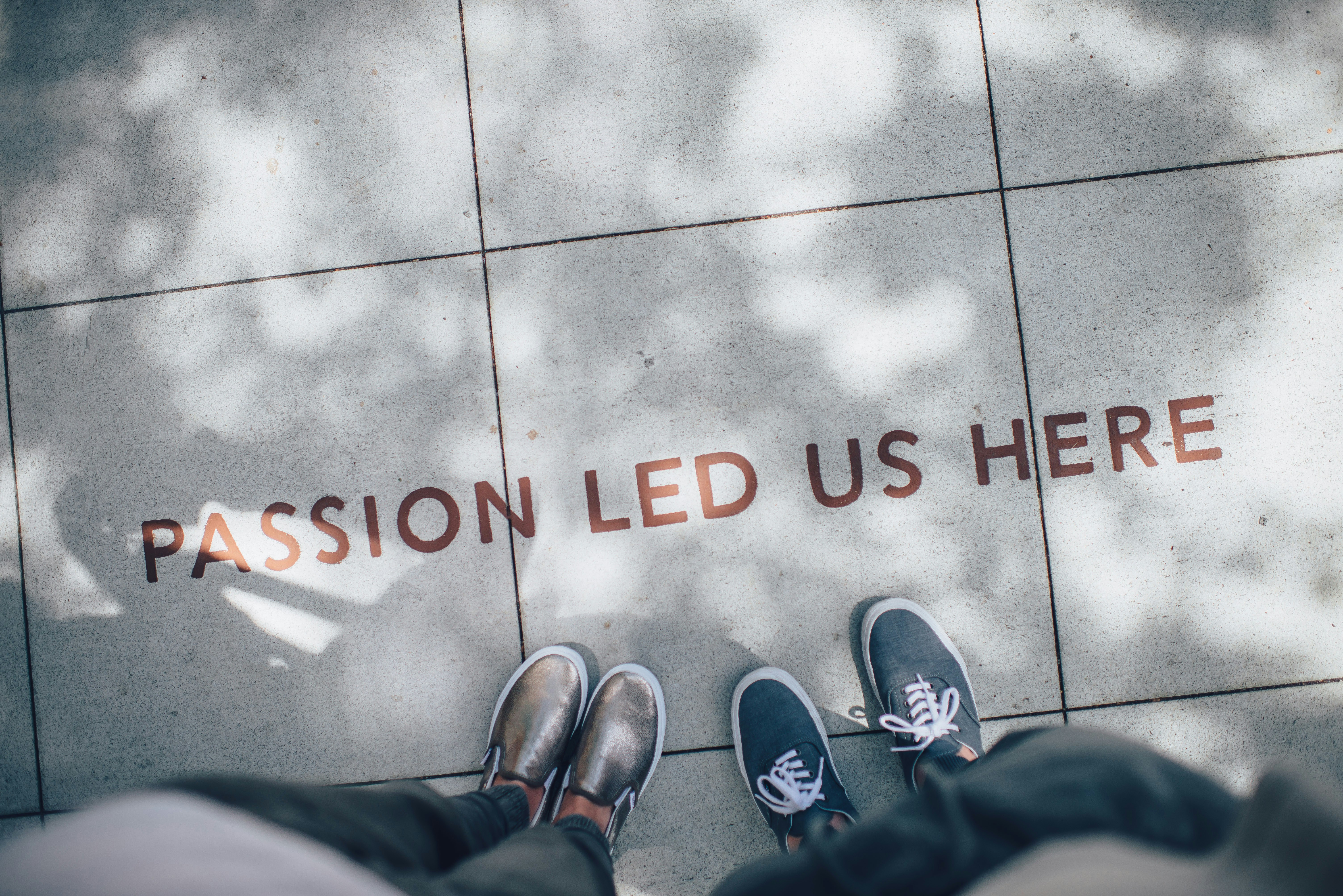 A sidewalk marked with the words: Passion Led us here